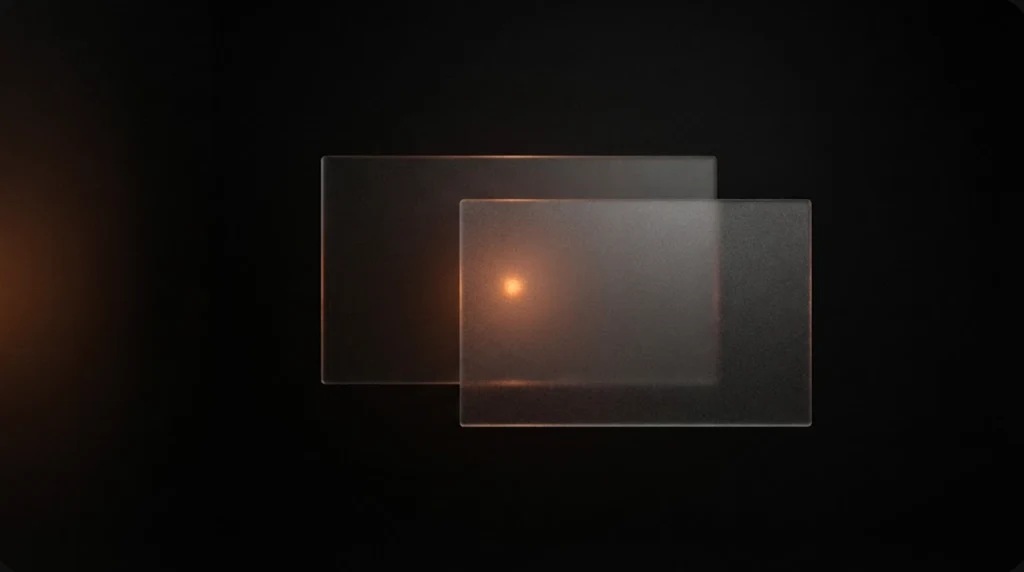 Two overlapping frosted glass panels floating in near darkness, lit from behind by a single small warm orange point of light